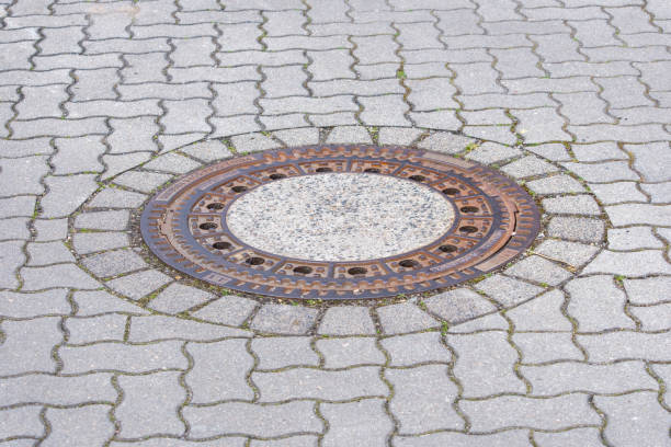 istock Manhole cover on a compound pavement road 1394438141