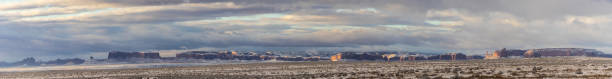 Panorama of Monument Valley covered in freshly fallen snow on a cloudy day stock photo