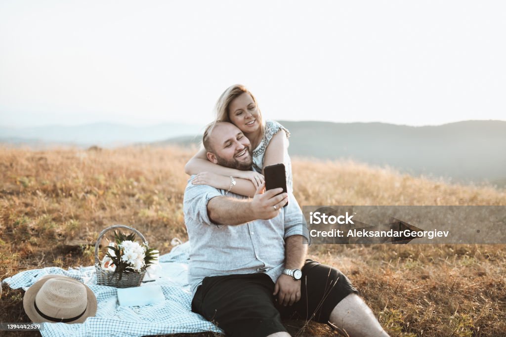 Freshly Married Couple Taking Selfie While They Enjoying In Picnic Trip Overweight Stock Photo