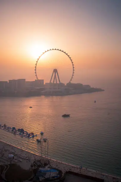 Bluewaters island in Dubai with Ain Dubai Ferris wheel seen from JBR beach in marina area at sunset