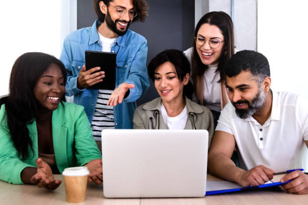 istock Group of multiracial coworkers work together using laptop in the office. 1394449952