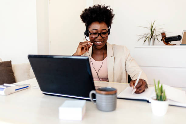 istock Young businesswoman taking notes in notebook while sitting in modern home office. 1394450886