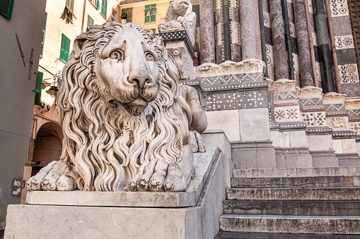 Genoa, stone statue of a lion at the entrance to the cathedral of Saint Lawrence (San Lorenzo), Italy