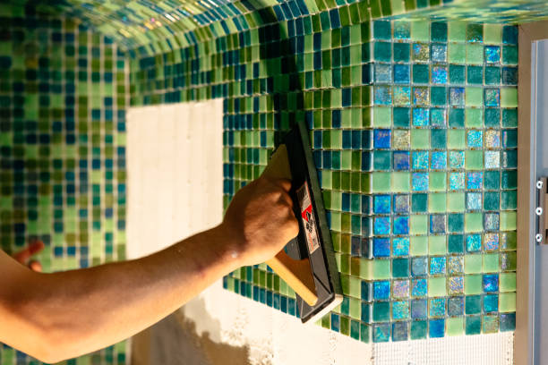 istock Worker applying mosaic tiles, renovation concept, Spa or sauna 1394452548