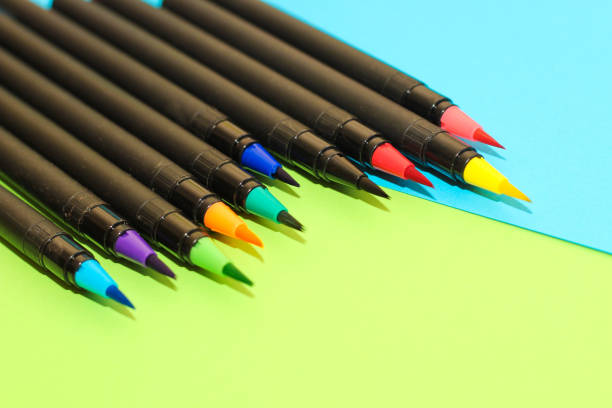 istock Multi-colored stationery felt-tip pens and brushes on a background of multi-colored cardboard paper 1394452795