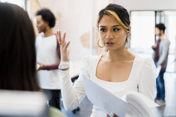 istock Woman gestures while coaching unrecognizable woman for part in play 1394454614