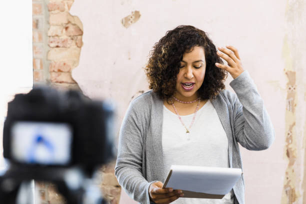 istock Woman reads something with emotion while filming herself 1394454619