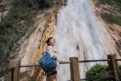 Young Caucasian woman near El Chiflon waterfall in Chiapas, Mexico during her travel