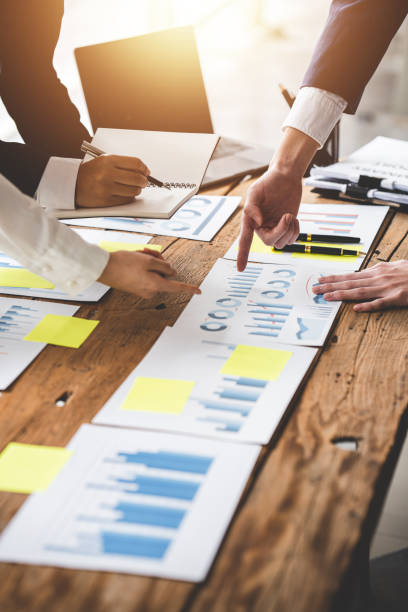 istock Teamwork with price chart analyzes business people on the table at the conference room. 1394458234