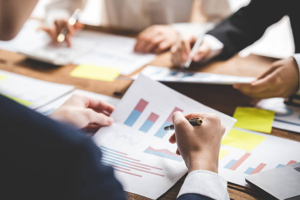istock Teamwork with price chart analyzes business people on the table at the conference room. 1394458297