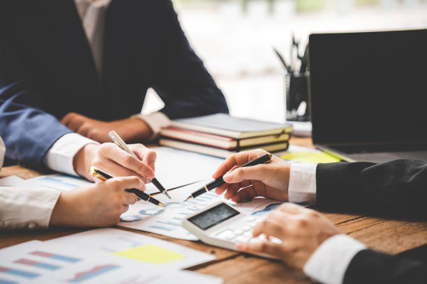istock Teamwork with price chart analyzes business people on the table at the conference room. 1394458348
