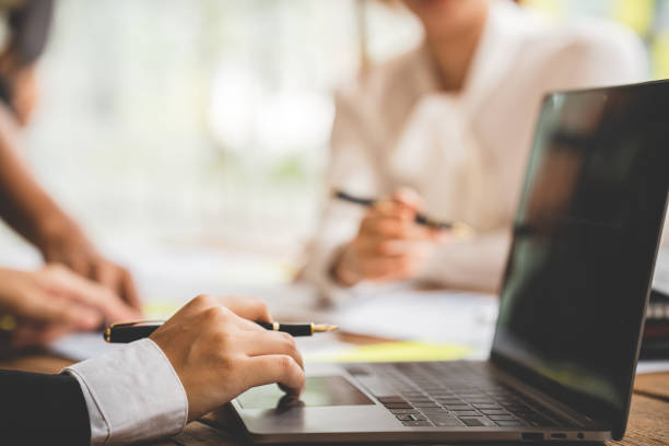 istock Teamwork with price chart analyzes business people on the table at the conference room. 1394458352