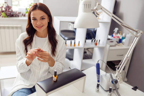 istock Joyful woman enjoying nail service in beauty studio 1394459307
