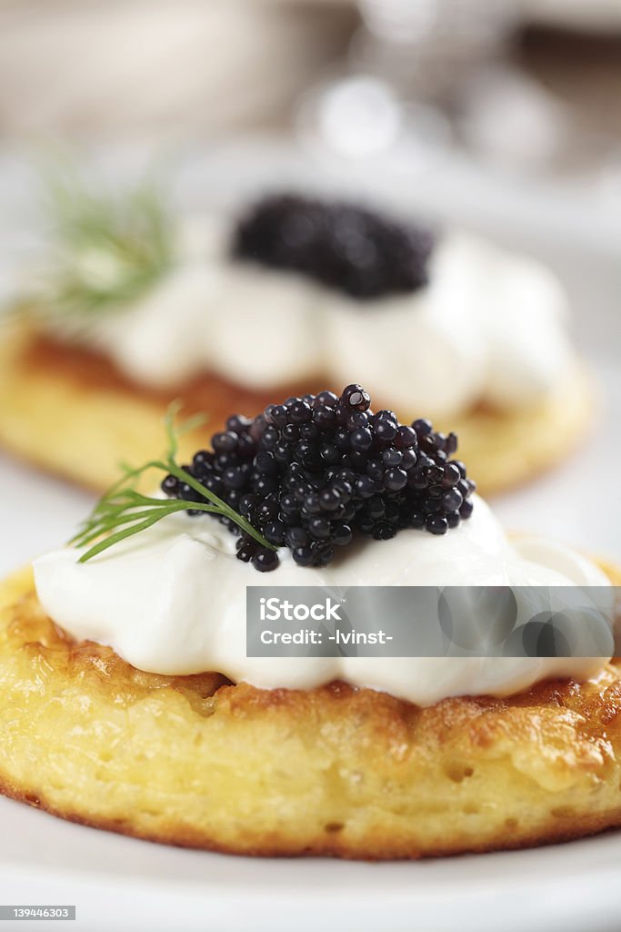 Close-up photograph of blinis topped with caviar Blinis with black caviar and sour cream Caviar Stock Photo