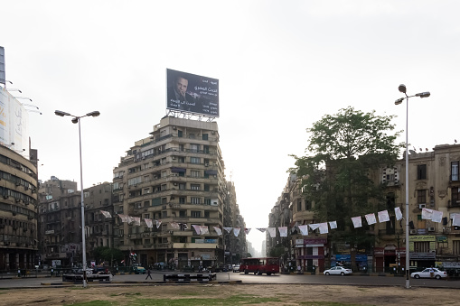 Cairo, Egypt – June 04, 2013 – Urban landscape of the city center at the Tahrir Square (Liberation Square), also known as Martyr Square, a major public town square in downtown Cairo