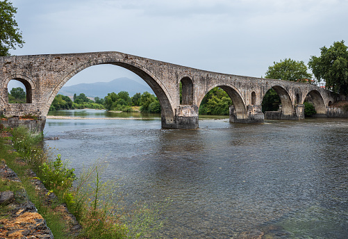 The Bridge of Arta is an old arched stone bridge that crosses the Arachthos river in the west of the city of Arta in Greece.