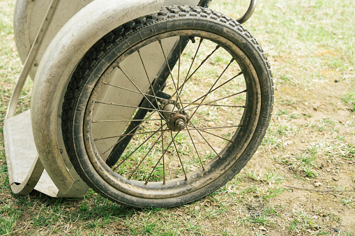 Old garden wheelbarrow wheel. Rusted metal. Spoked wheel