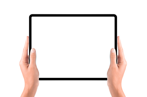 Hand holding blank screen tablet computer on white background.