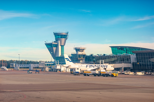 A Finnair airplane is parked at Helsinki Vantaa International Airport Finland in Helsinki, Finland on a sunny day.