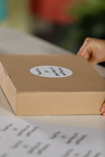 istock Woman holding a package with ''thank you'' label on it 1394486190