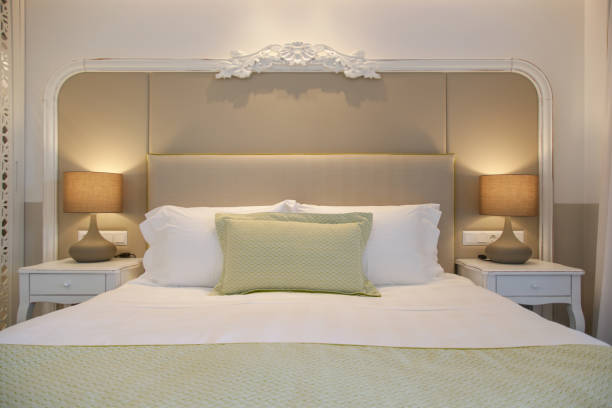 istock Cozy and elegant bedroom. King size bed with bedside lamp. 1394487994