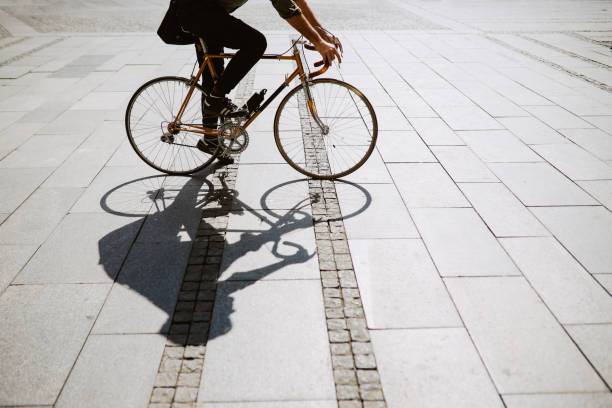 Mid aged man commuting on his vintage road bicycle through the city streets.
