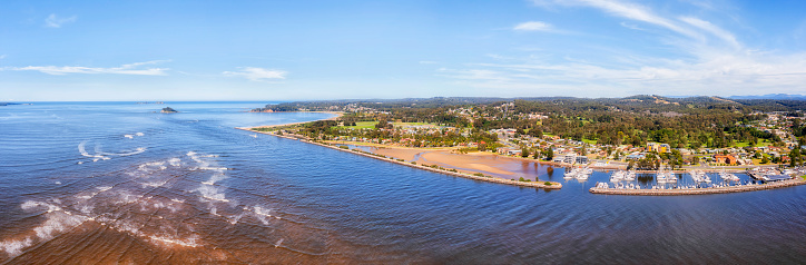Entrance of Clyde river to Pacific ocean on South coast of Australia at Batemans bay town - wide aerial panorama.