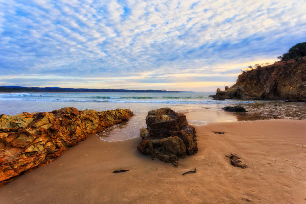 istock Tathra beach sand rocks rise 1394497858