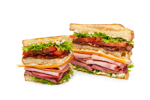 два куска клубного сэндвича на белом - sandwich club sandwich ham turkey стоковые фото и изображения