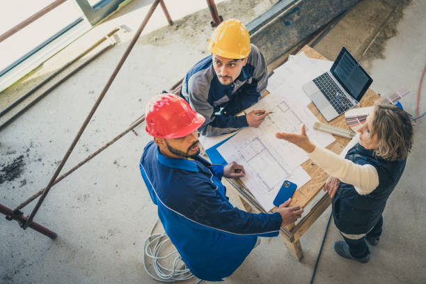 istock Group of people discussing on construction site 1394500424