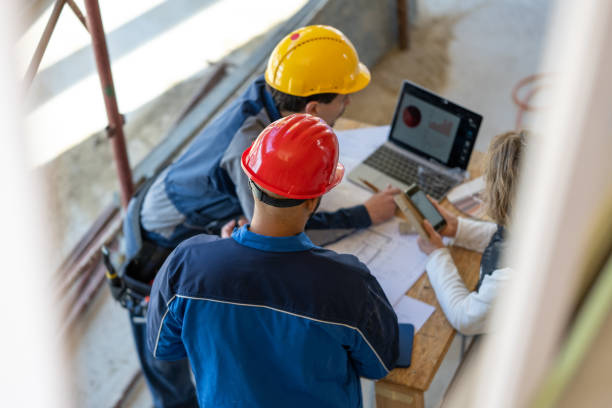 istock Building professionals searching information in laptop 1394500426