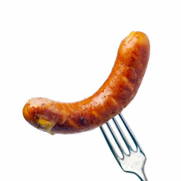 Grilled sausage on fork over white background stock photo