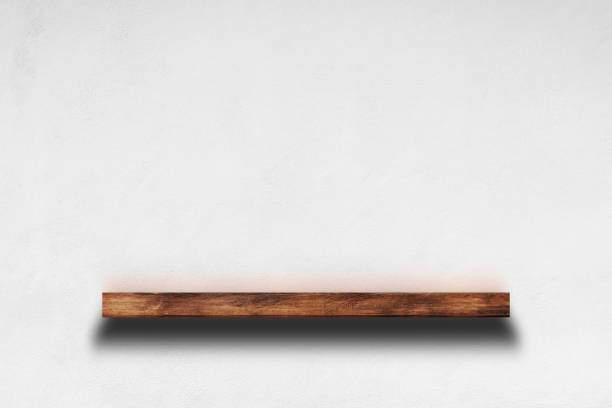 istock Wooden shelf on white concrete wall background for decorative design. 1394501615