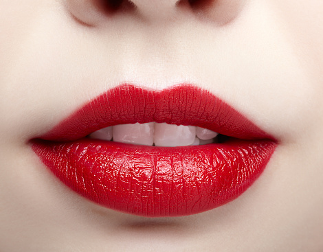 young woman sensual lips with red lipstick makeup.