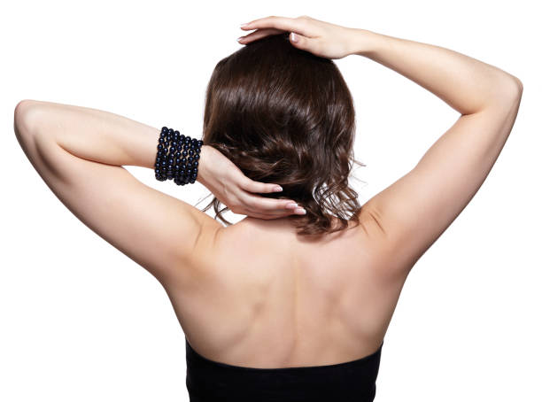 istock Brunette woman from backside on gray background 1394513270