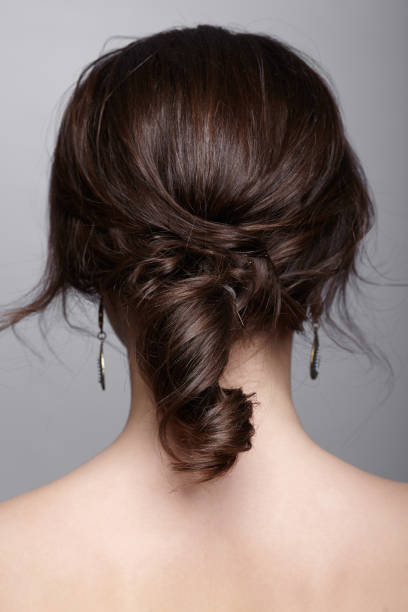 istock Brunette woman from backside on gray background 1394513275