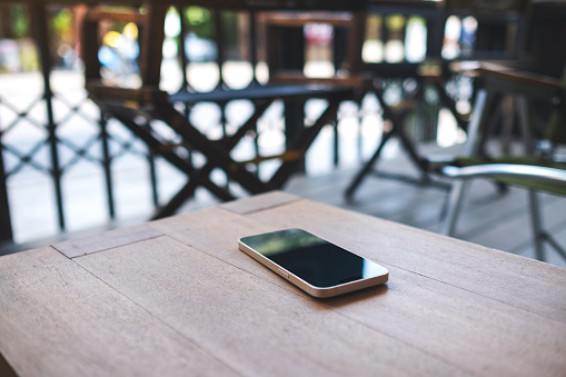 A single mobile phone on wooden table