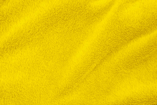 istock Yellow clean wool texture background. light natural sheep wool. yellow seamless cotton. texture of fluffy fur for designers. close-up fragment white wool carpet. 1394517219