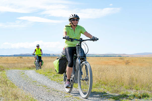 Mature couple ride electric mountain bikes