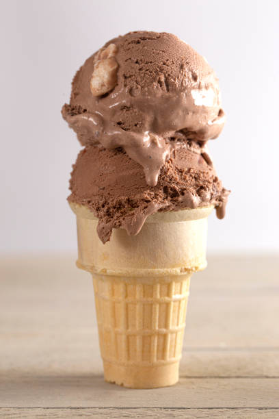 istock Chocolate Rocky Road Ice Cream Cone on a Wooden Table 1394523959