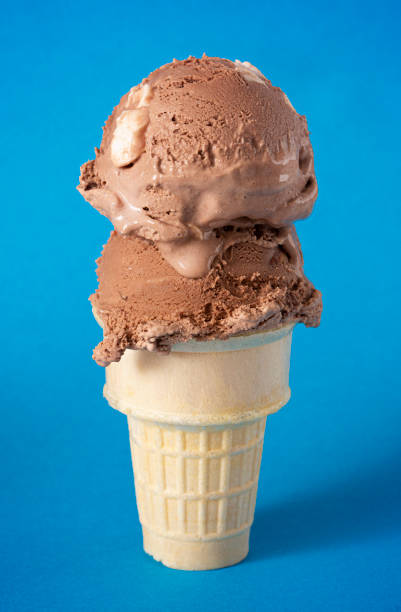 istock Chocolate Rocky Road Ice Cream Cone on a Blue Background 1394524525