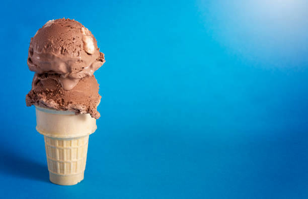 istock Chocolate Rocky Road Ice Cream Cone on a Blue Background 1394524526