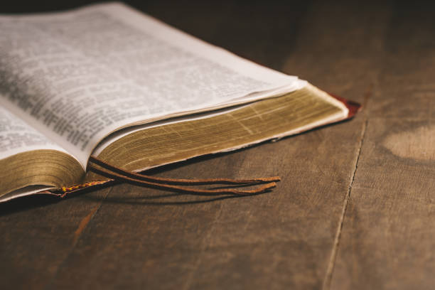 istock Open Book on wood background. Religion concept.