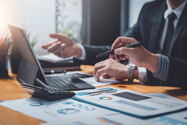 istock Business people meeting explaining the financial graph data and marketing plan. Group of business people at meeting assessment the state of business investment and marketing. 1394526260