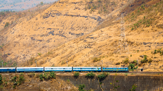 Nashik, India - March 13, 2016 : Indian railway passing through the mountains
