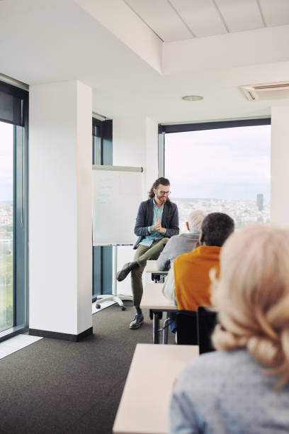 istock Young educator teaching a multicultural group of senior students in the classroom. 1394531032