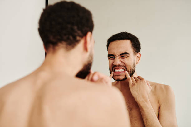 istock Young man examining health of his teeth 1394532485