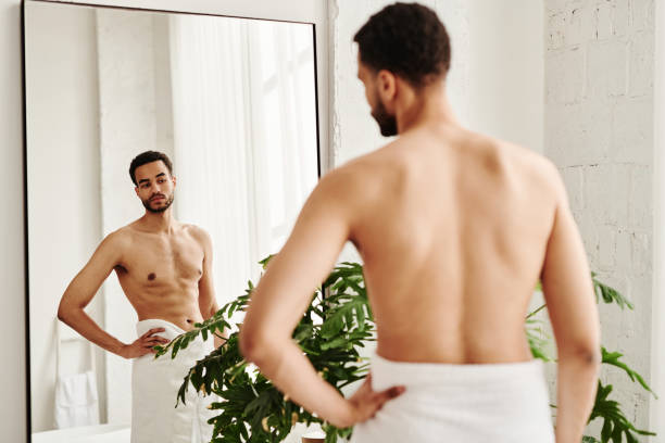 istock Man looking at his muscular body 1394532509