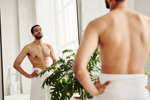 istock Young man admiring his perfect body 1394532513