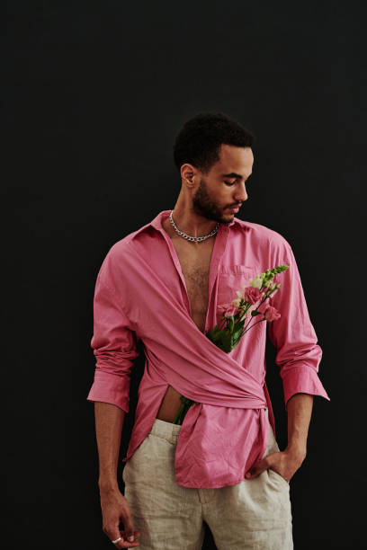 istock Groomed handsome man in pink shirt 1394532710